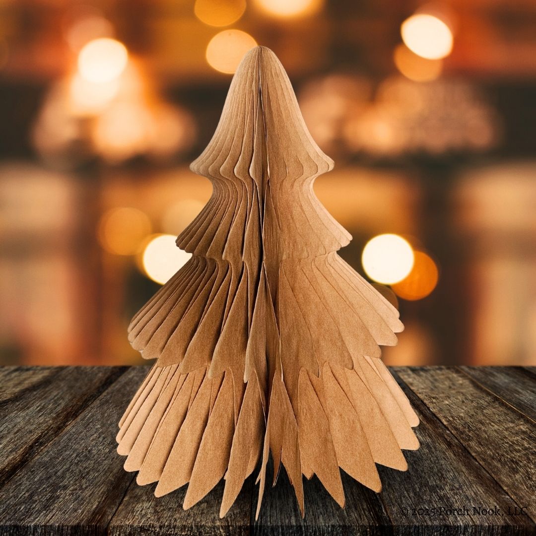 Craft Paper Christmas tree on a wooden surface with blurred lights in the background