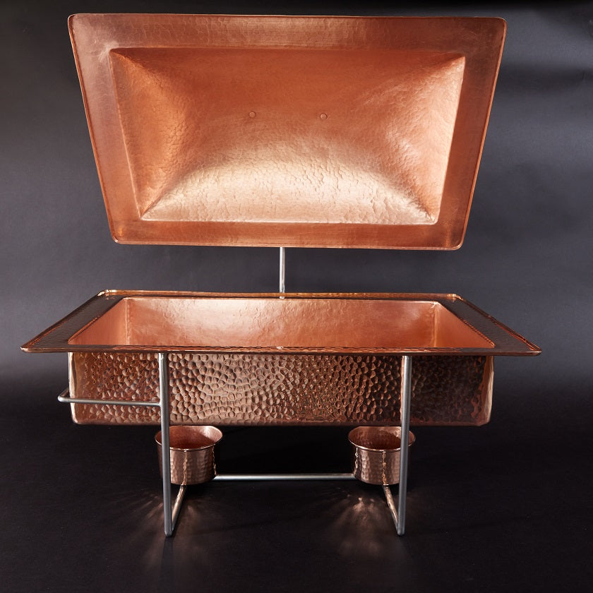 Copper tray and basin set on a dark background