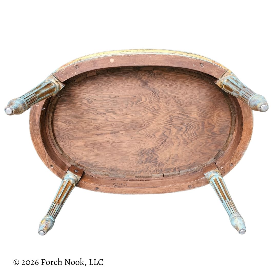 Underneath French Provincial style chair, with metal floor protectors