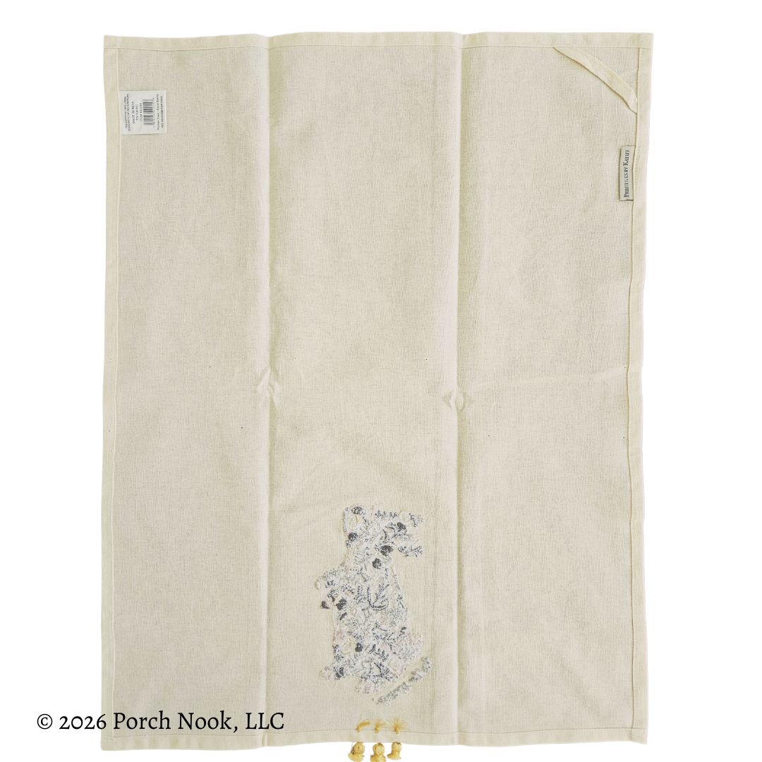 Backside of tea towel with floral embroidery on a white background