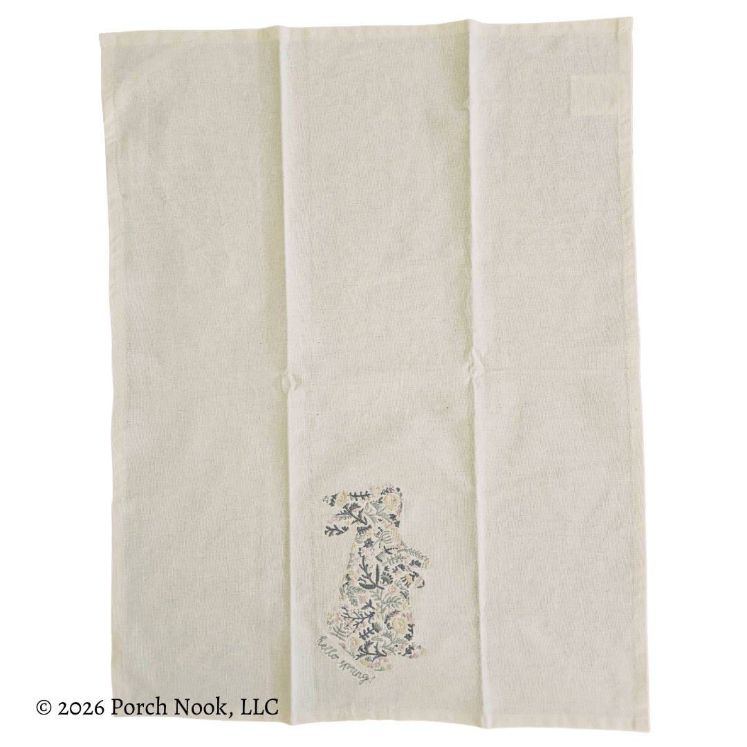 Frontside of tea towel with floral design on a white background