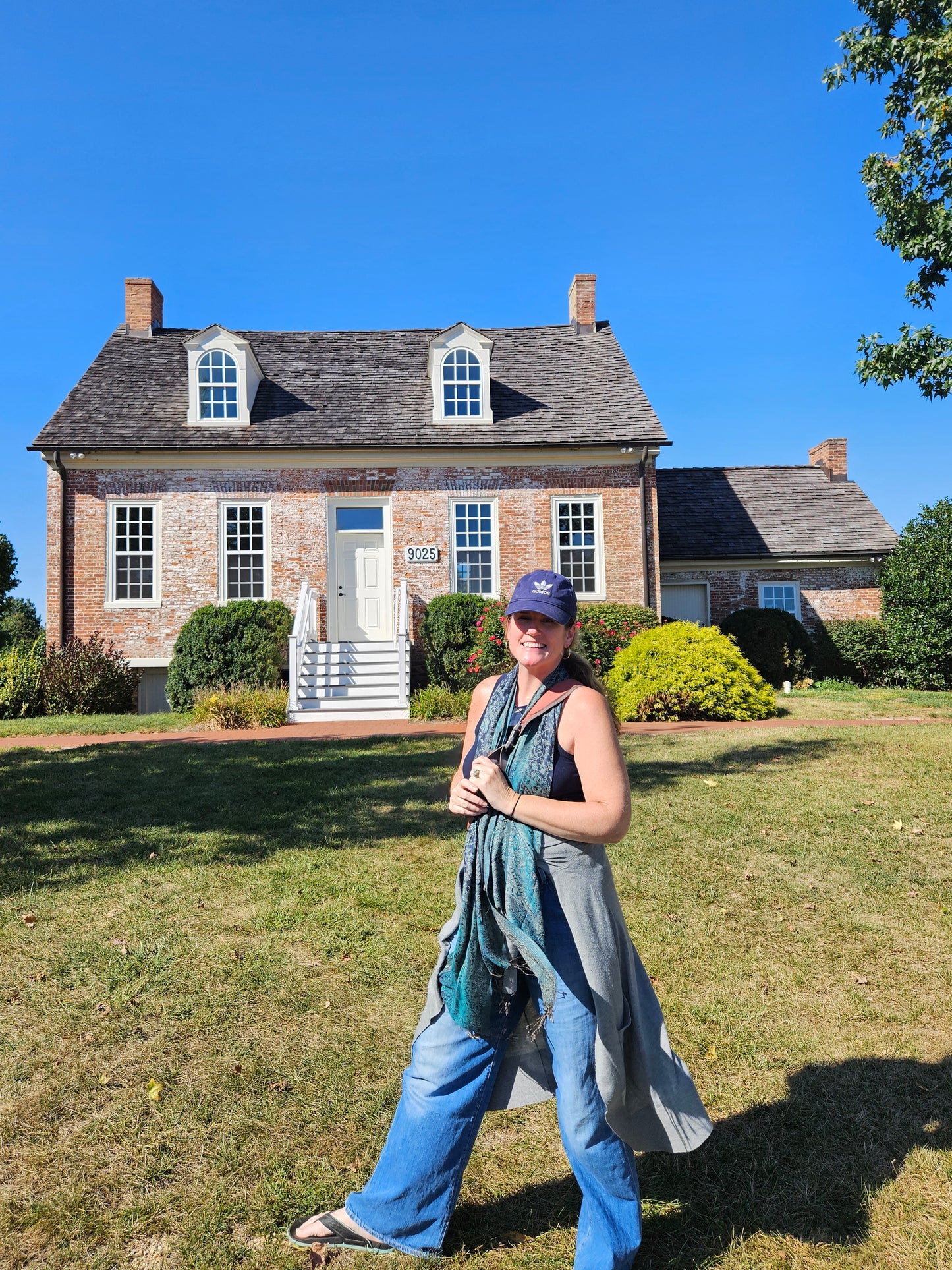 Porch Nook owner Kristin LeDuc standing in front of Frederick County Maryland's historical landmark, The Fat Oxen House