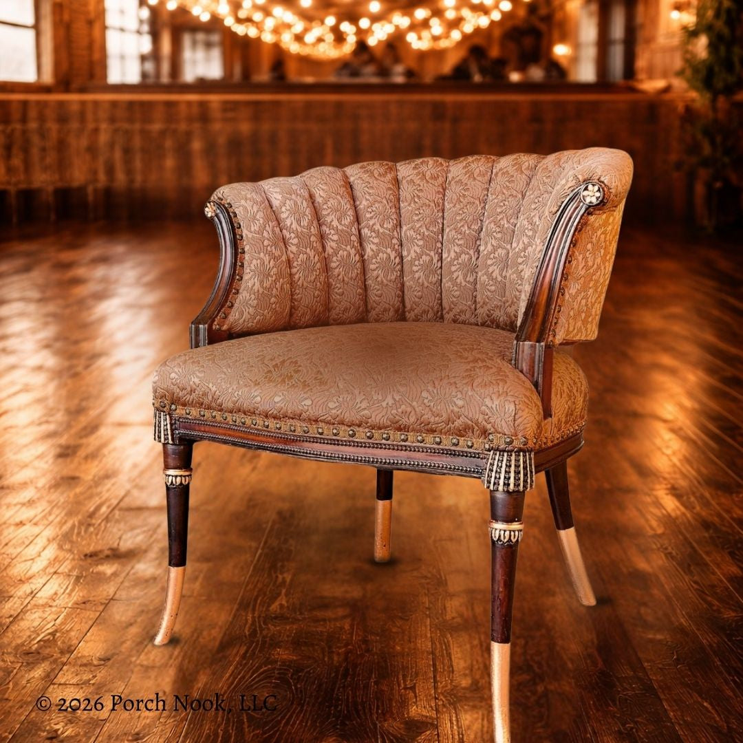 Decorative chair with patterned fabric on a wooden floor, lit by warm lights.