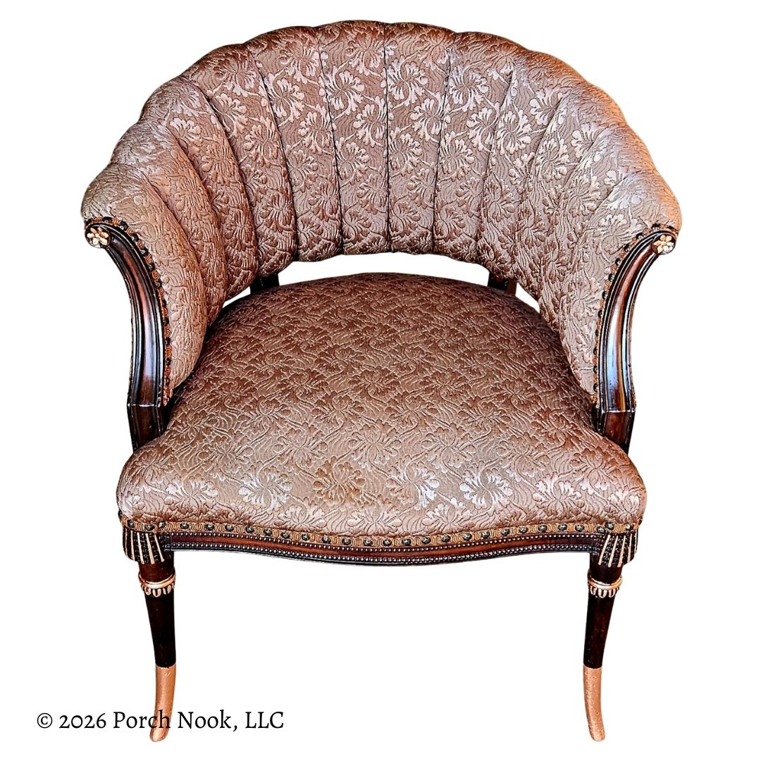 Decorative armchair with intricate floral pattern on a white background