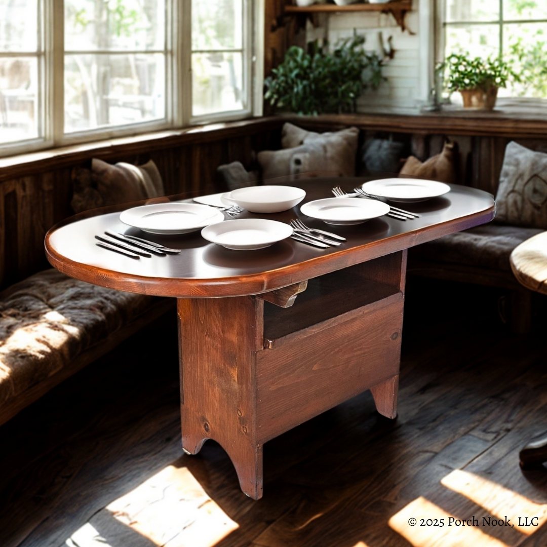 Vintage Pennsylvania Dutch Convertible Tilt-Top Table with Bench Seat and Storage - Wooden dining table set with plates and cutlery in a cozy room with windows and plants.