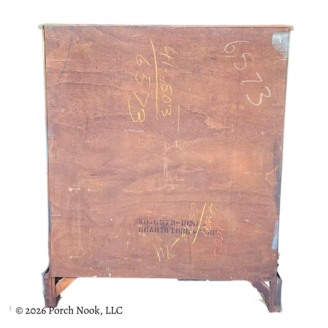 Back view of vintage secretary desk displaying original wood paneling and structural base details
