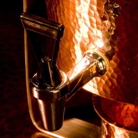 Close-up of spigot on copper finish dispenser.