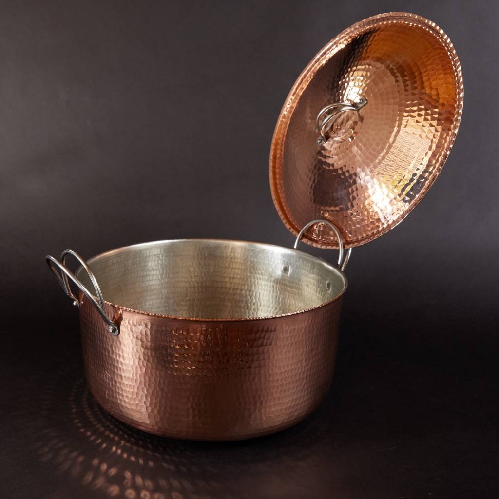 Copper pot with a lid on a dark background