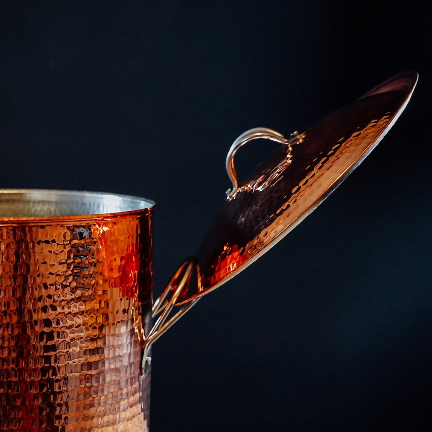 A copper stock pot and lid