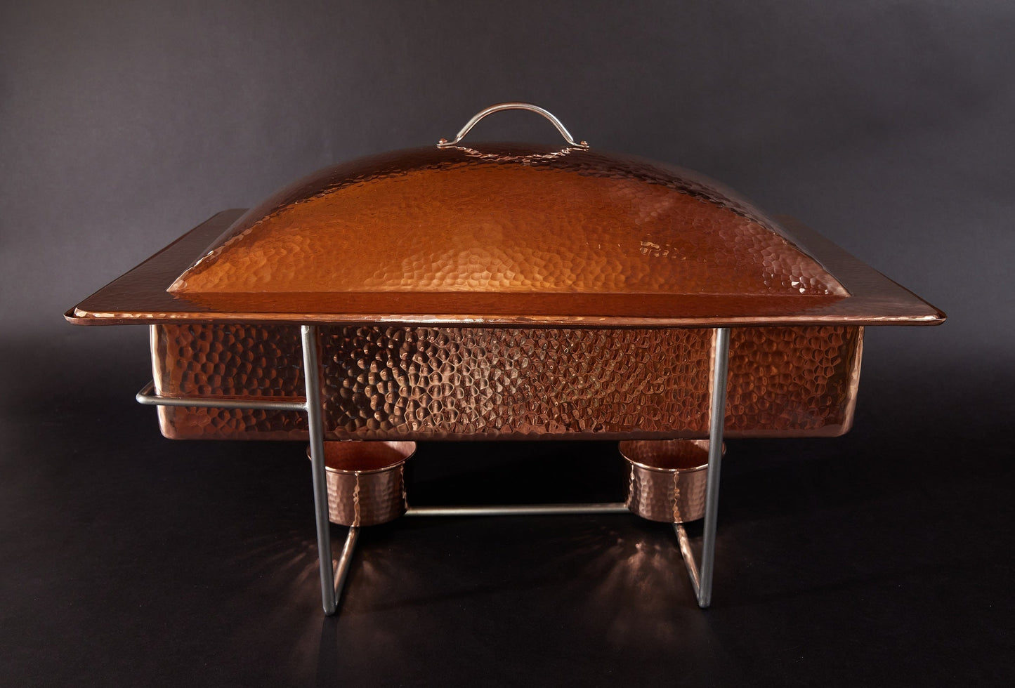 Copper chafing dish on a black background