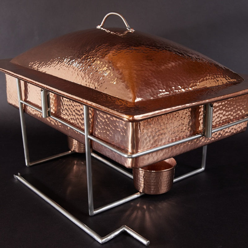 Copper chafing dish with a dark background