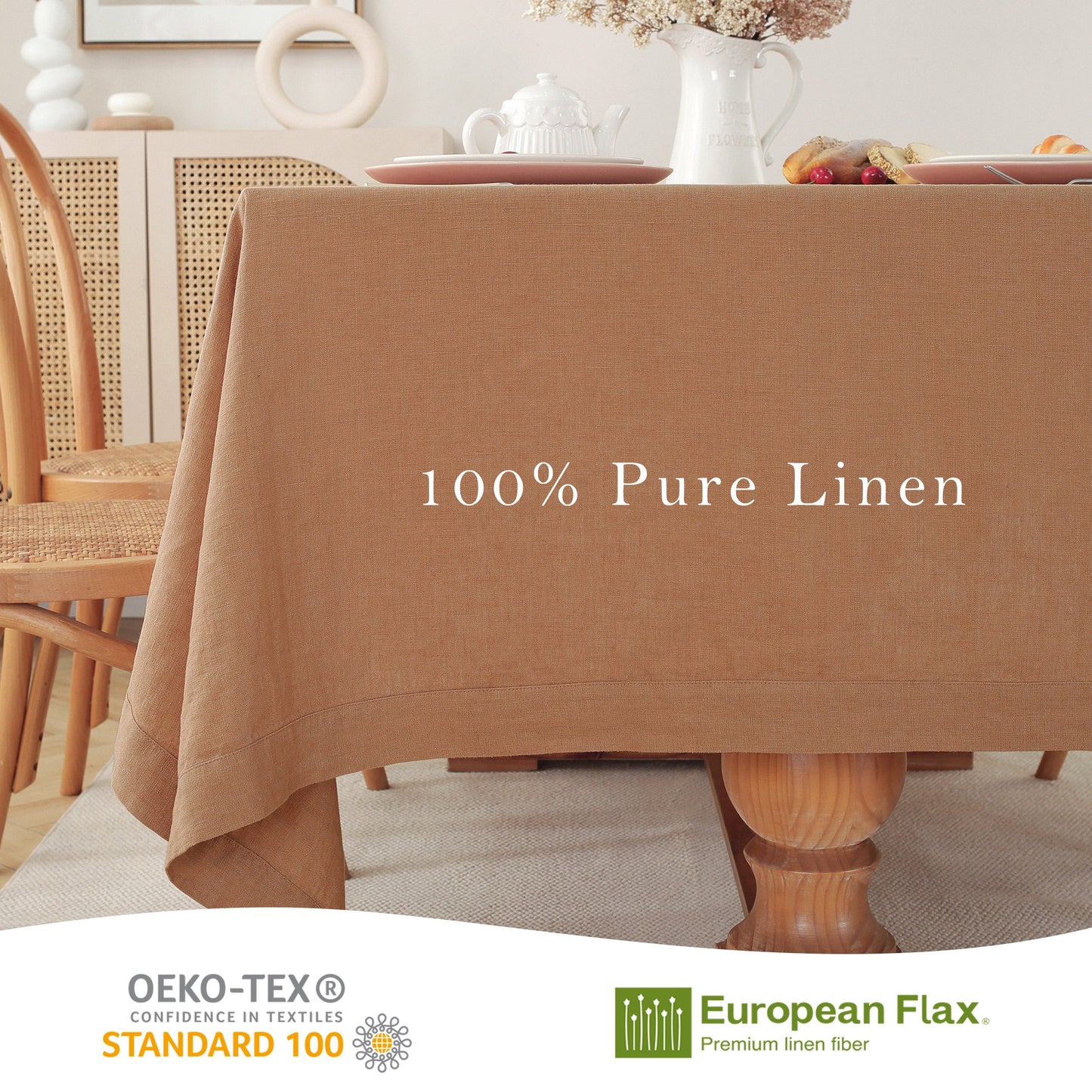 A tan-brown linen tablecloth draped over a wooden dining table in a bright, styled dining room. White text on the table reads '100% Pure Linen'.