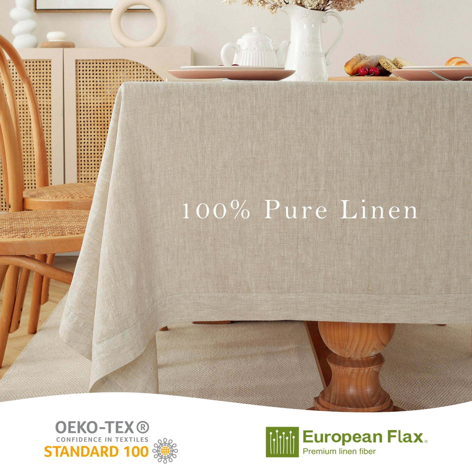 A beige linen tablecloth draped over a wooden dining table in a bright, styled dining room. White text on the table reads '100% Pure Linen'.