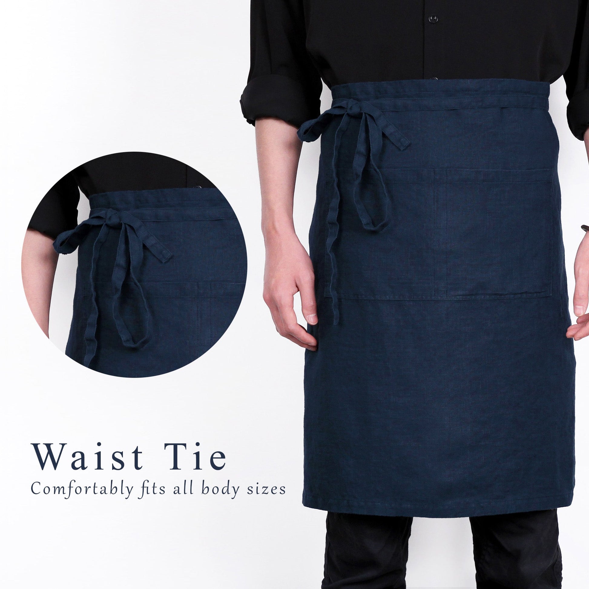 A dark navy blue linen apron with a waist tie, modeled on a person wearing a black shirt and pants. The image includes a circular inset showing the waist tie detail and text that reads 'Waist Tie Comfortably fits all body sizes'.